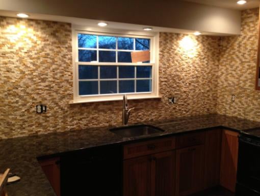 Kitchen remodel with stone mosaic backsplash and granite countertops